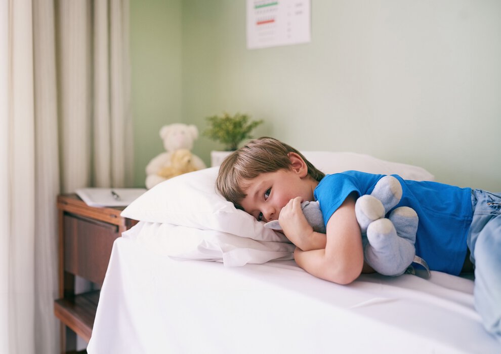 Hospital, bed and portrait of boy with teddy bear, smile and medical consultation for kids healthcare. Relax, healing and child in bedroom at clinic with stuffed animal, professional care and health.