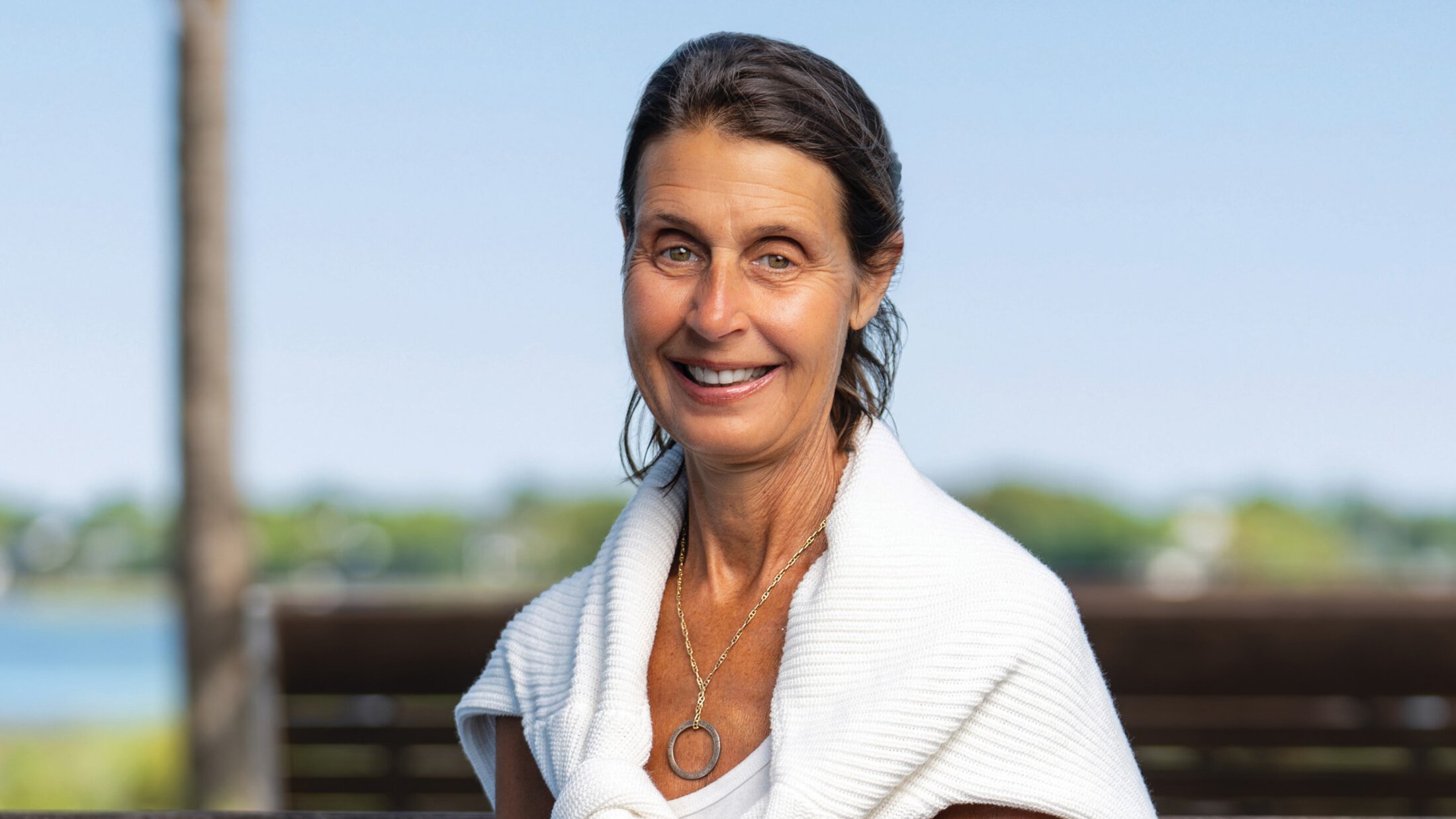 headshot of Ruth Sykora with a white sweater tied around her shoulders