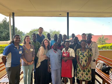 A group of clinicians stands together in Uganda.
