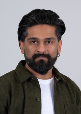 Raajaram Gowrishankar PhD Neuroscience wearing a white shirt and green dress shirt