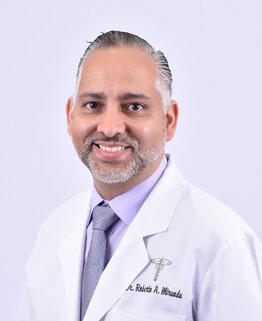 Dr. Roberto Miranda wearing a white coat