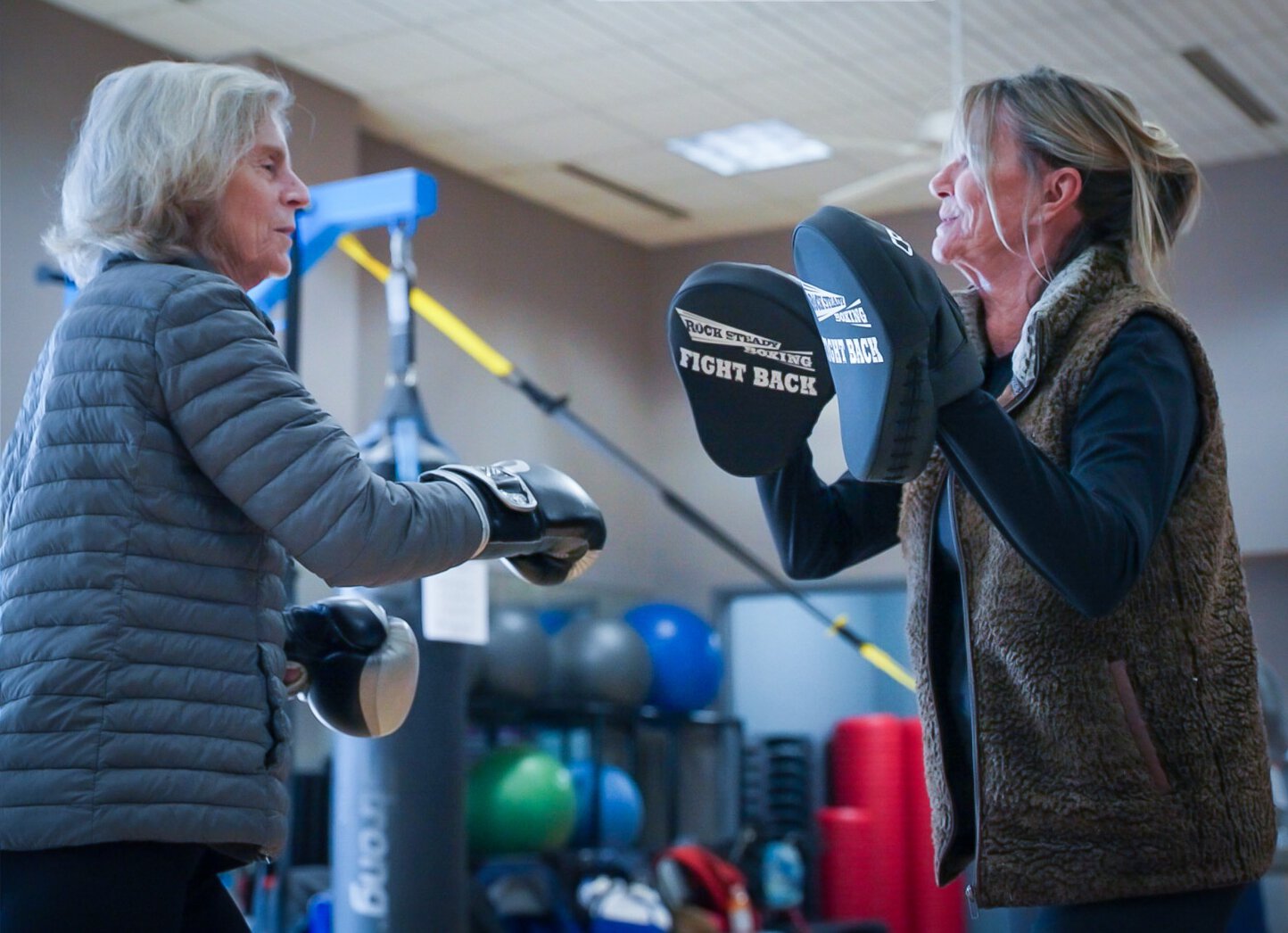 Lyn Swan participates in the Rock Steady Boxing activity at the Wellness Center with her sister-in-law Jennie Swan.