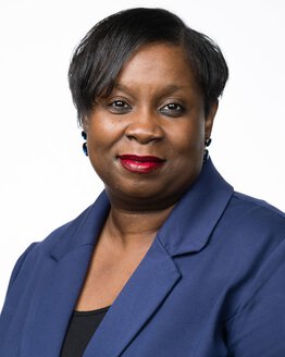 April Heyward is an Assistant Professor and Director of Artificial Intelligence Integration and Creative Learning at the Medical University of South Carolina wearing a blue suit with black shirt