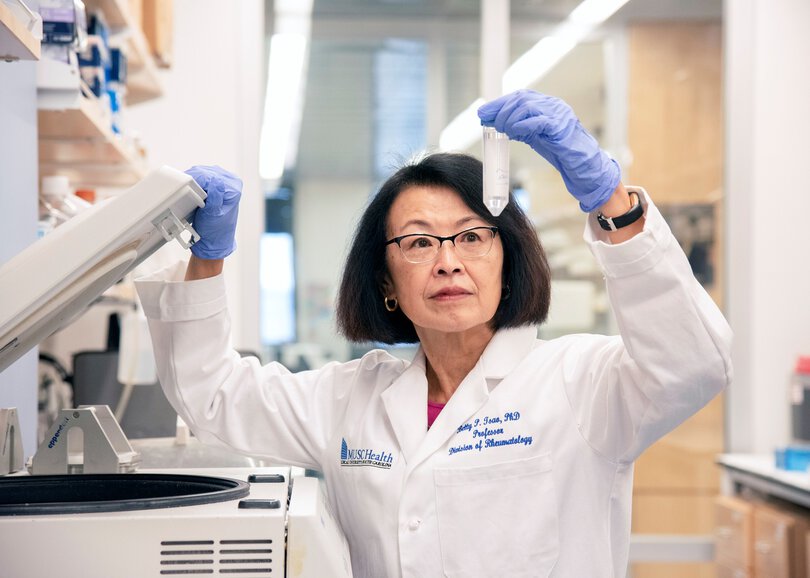 Researcher looking at lab specimen
