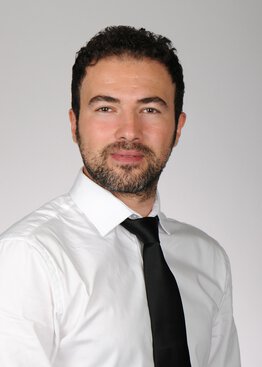 Ismail Kabakus wearing a tie and white shirt