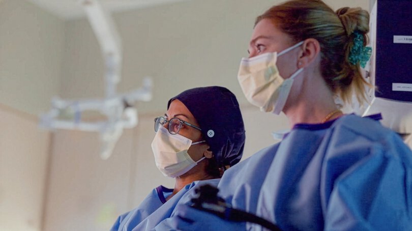 Attending and fellow perform procedure in clinic