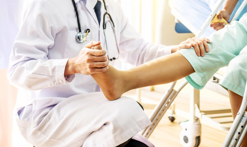 Doctor and patient - Doctor examining of the leg from the knee and ankle patient in hospital