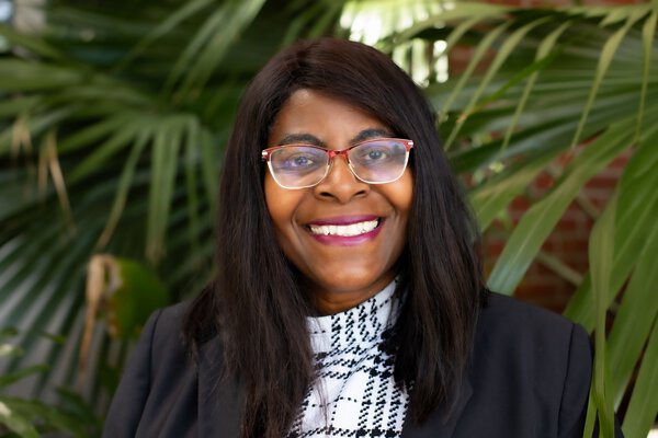 Dr. M. Ford, MUSC Hollings Cancer Center, standing in front of a palm tree