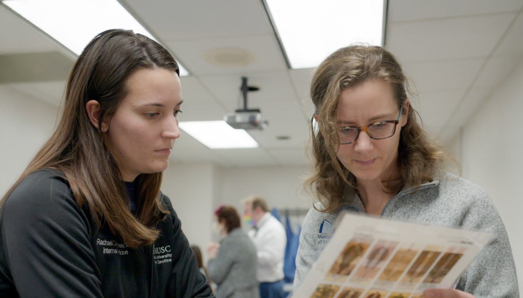 Associate program director reviewing chart with fellow
