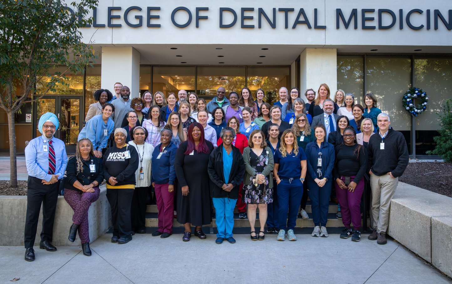 Staff at the College of Dental Medicine smiling.