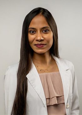Dr. Priyal Agarwal, wearing a lab coat