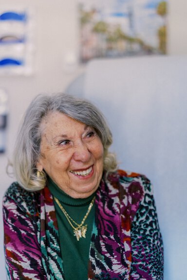 Patient smiles at doctor during appointment.