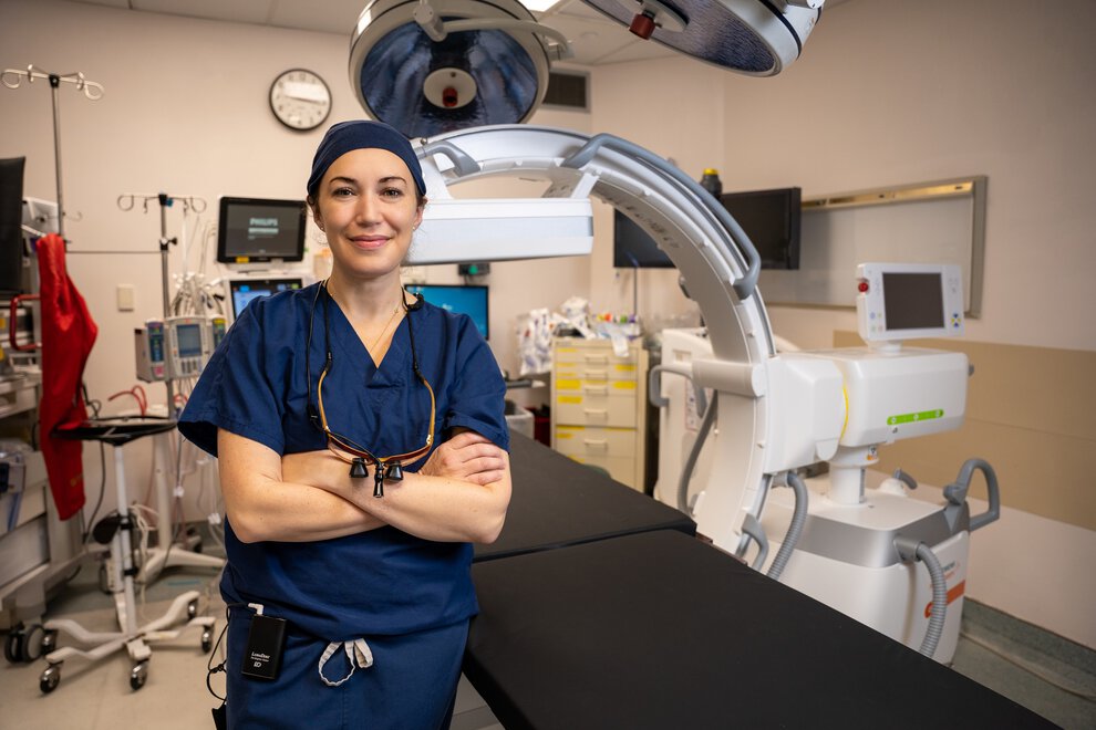 A surgeon poses in the operating room.