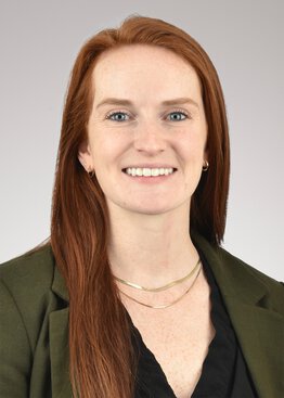 Elizabeth Crowley, MHA, Executive Director, Leatherman Behavioral Care Pavilion wearing a green sweater