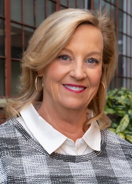 Katy Symonette wearing a black ad white sweater