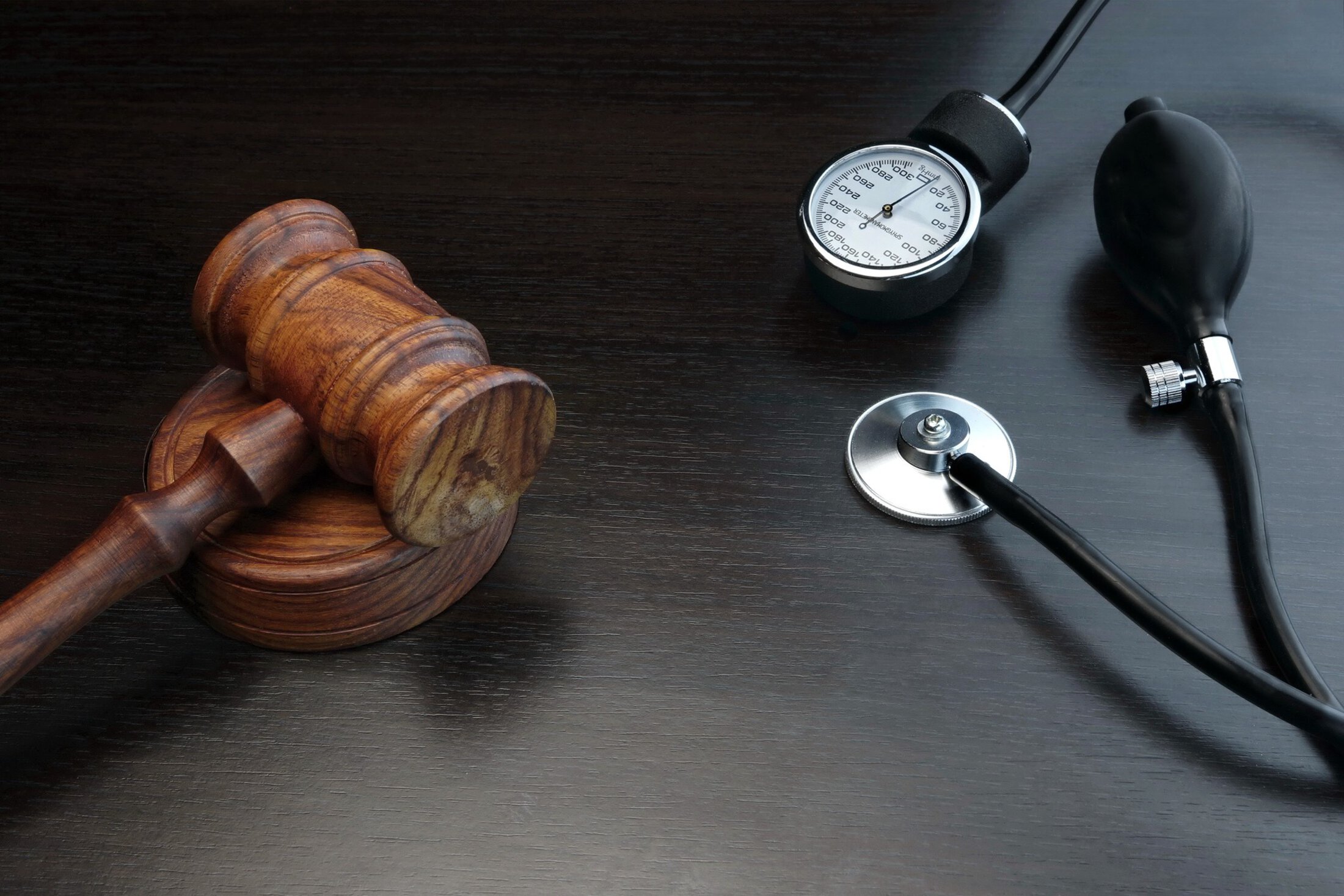 Judge's gavel and sound block with stethoscope close-up