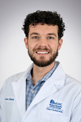 Braden Oldham, MD wearing a white coat