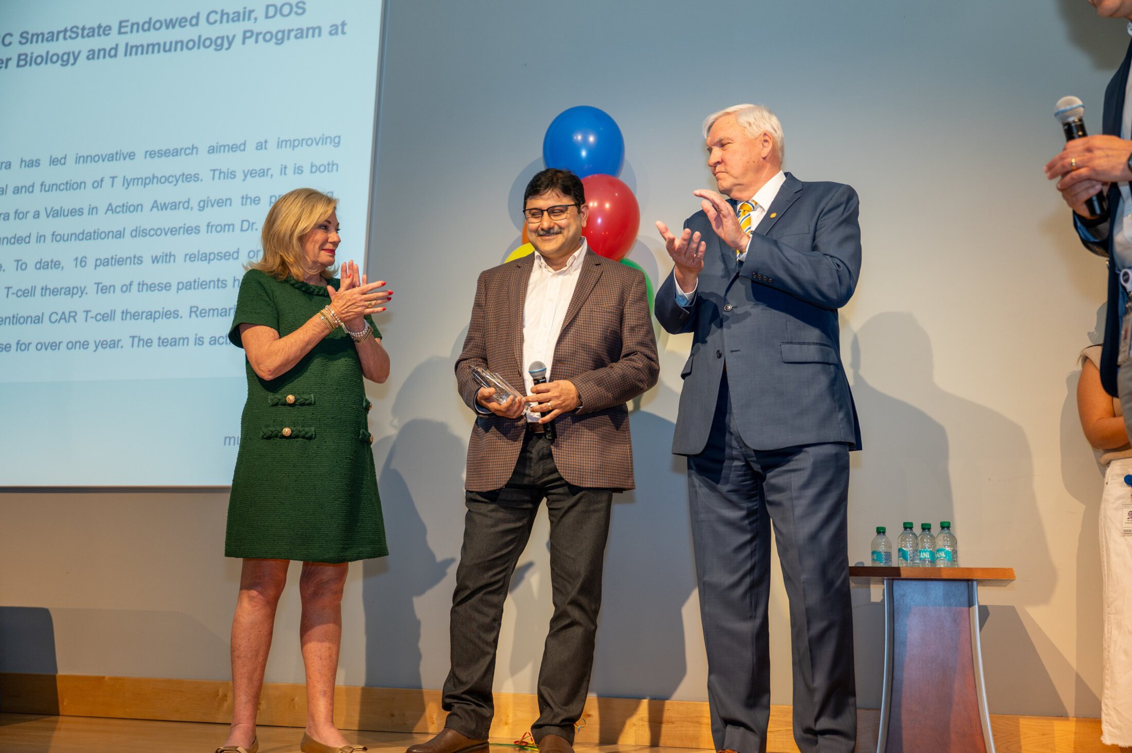 Values In Action Ceremony 2025. Mr and Mrs Dr. Cole handing recipient an award