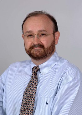 Istvan Takacs, MD, Neurosurgery, Cancer - Brain & Spine Tumors wearing a blue dress shirt and dark blue tie