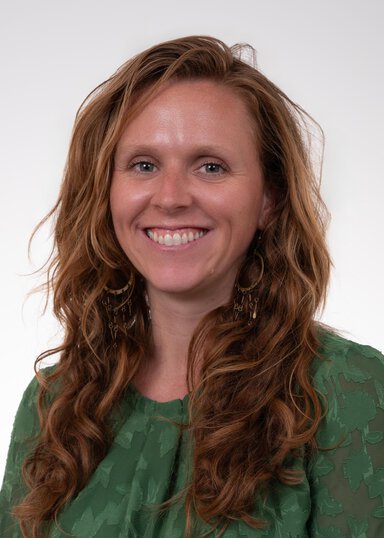 Lauren Dillard PhD Otolarynology Faculty wearing a green dress