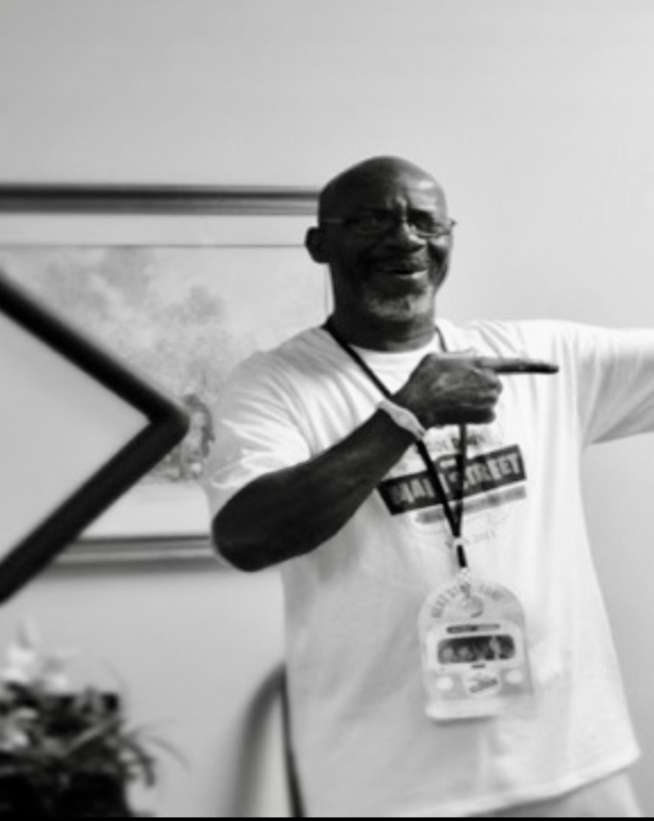 A man makes a pointing gesture as he speaks to a group.