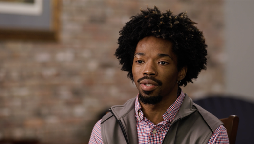 close up of a man speaking to the camera