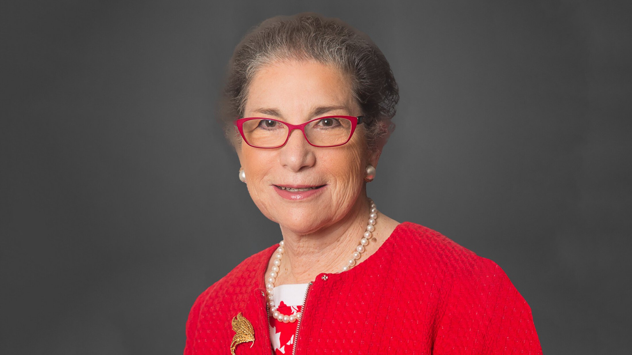 headshot of Patricia Ganz in a red sweater